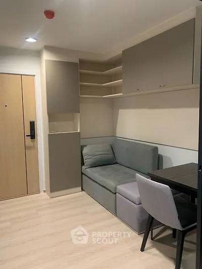Modern apartment interior with cozy seating and sleek storage solutions.