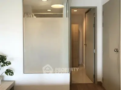 Modern bathroom with frosted glass and wooden accents