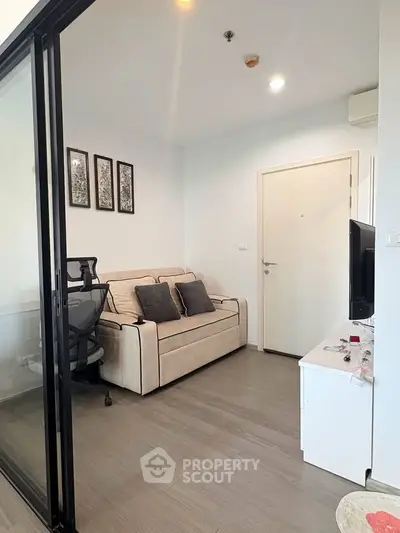 Modern living room with sleek design and comfortable seating in a stylish apartment.