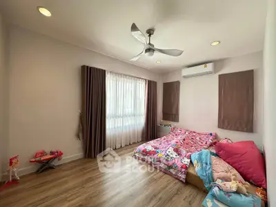 Charming bedroom with playful decor and ample natural light