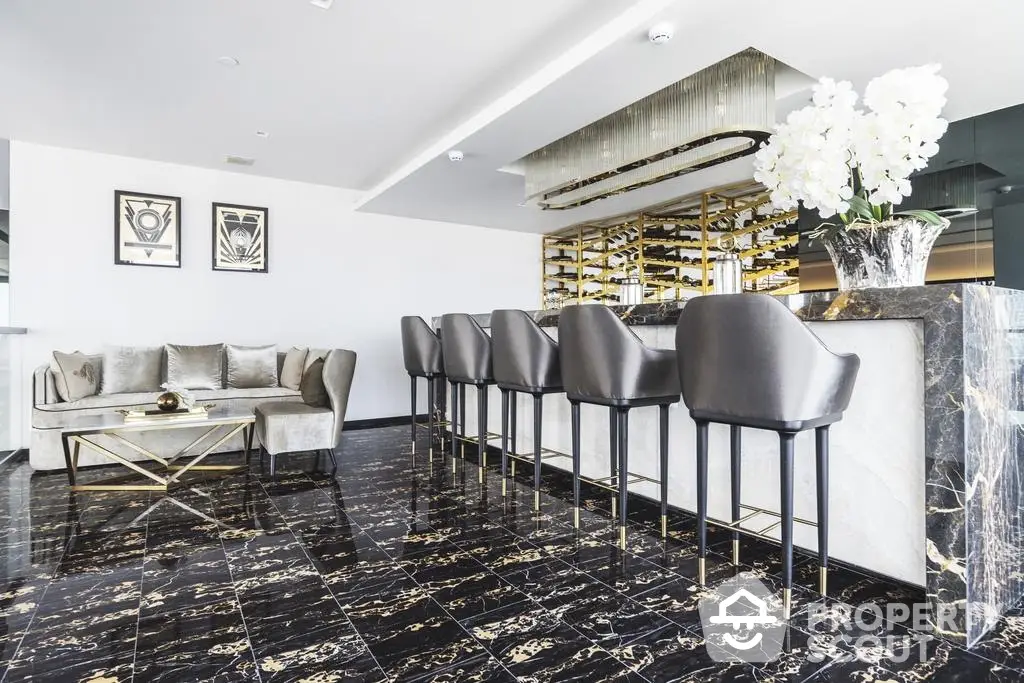 Luxurious open-plan living space with polished marble floors, modern bar seating, and elegant decor, perfect for upscale urban living.