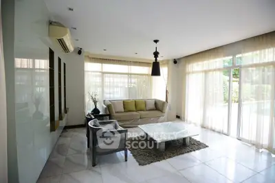 Spacious living room with modern decor and large windows for natural light.
