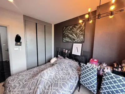 Cozy bedroom with modern decor and ample natural light