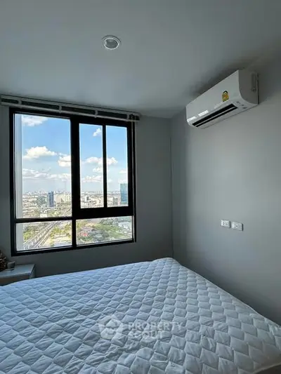 Modern bedroom with city view and air conditioning in high-rise apartment