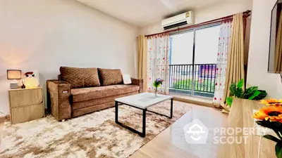 Cozy living room with plush sofa, modern decor, and balcony view