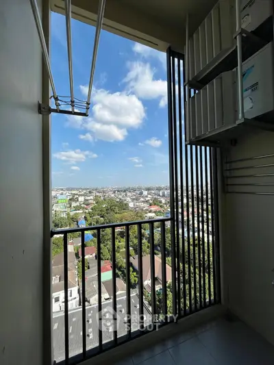 Stunning high-rise balcony view overlooking cityscape with clear blue skies.