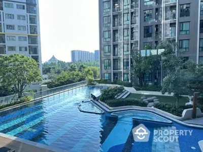 Luxurious condominium with stunning pool and lush garden view