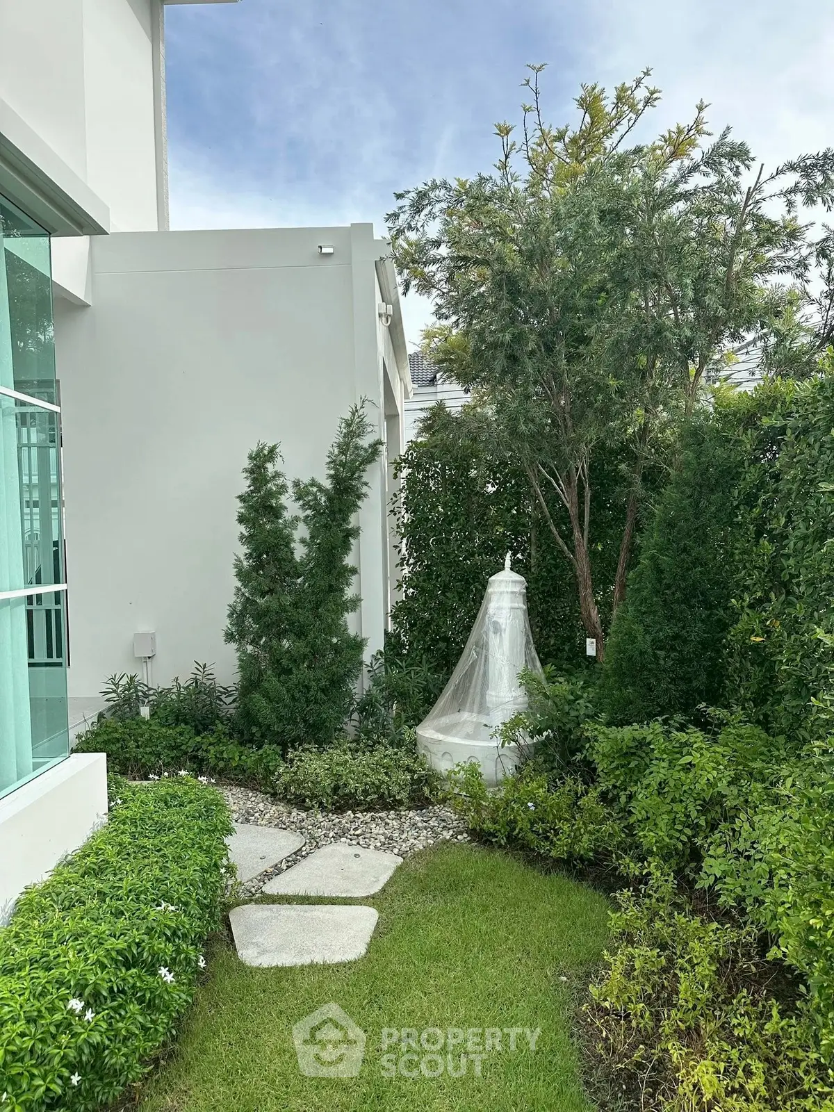 Charming garden view with lush greenery and modern architecture