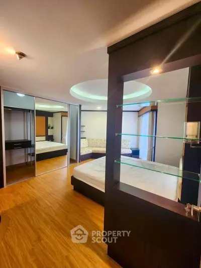 Spacious bedroom with modern design and mirrored closet doors
