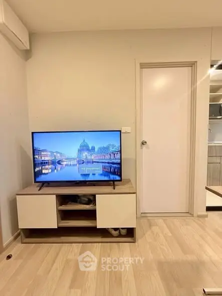 Modern living room with sleek TV stand and wooden flooring