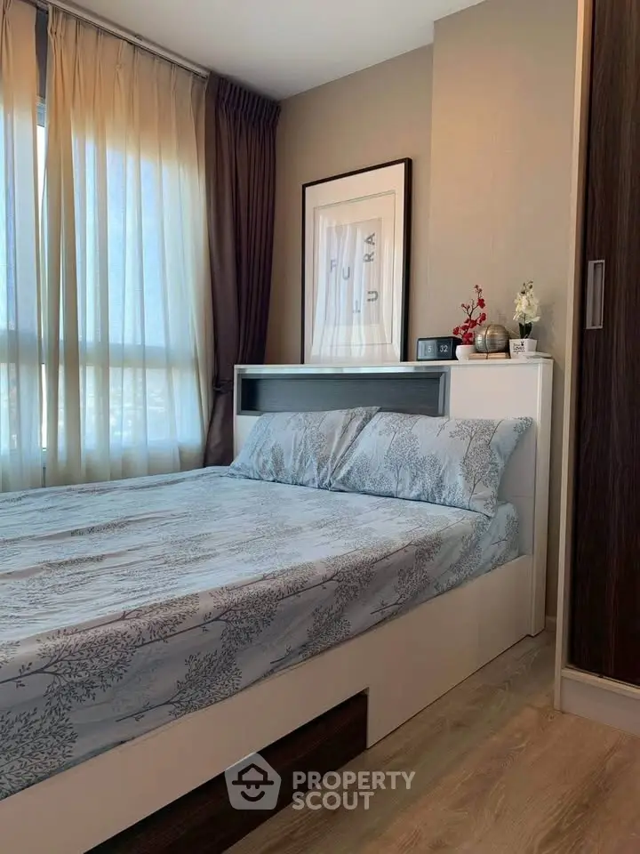 Cozy bedroom with modern decor and natural light, featuring a stylish bed and elegant curtains.
