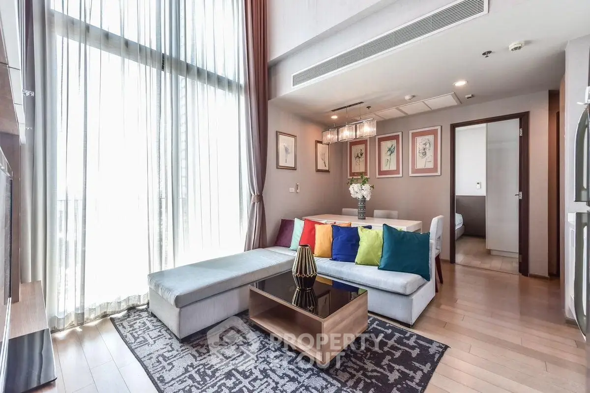 Luxurious living room with high ceilings and colorful decor in modern apartment