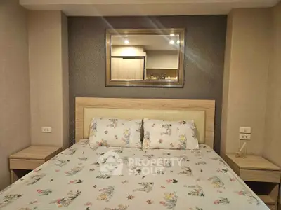 Cozy bedroom with elegant decor and plush bedding in a modern apartment.