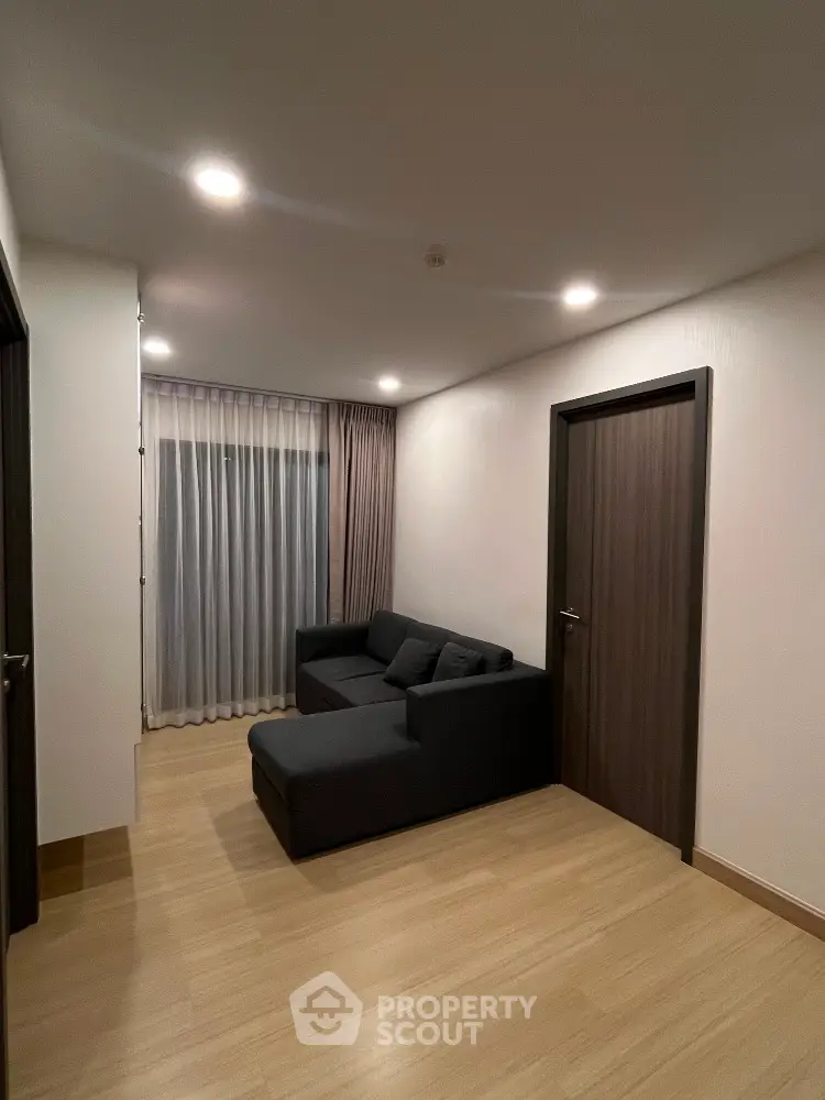 Modern living room with sleek design and cozy sofa, perfect for relaxation.