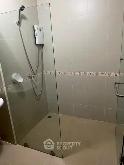 Modern bathroom with glass shower enclosure and tiled walls