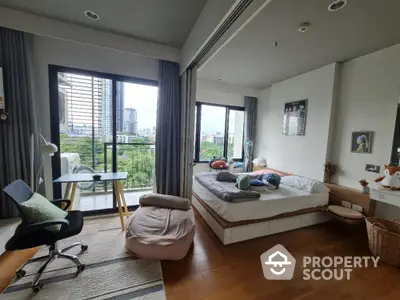 Spacious bedroom with city view and modern decor, featuring a cozy study area.