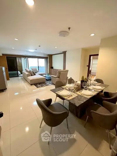 Spacious modern living room with elegant dining area and stylish furniture.