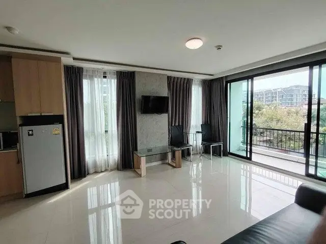 Spacious modern living room with large windows and balcony view