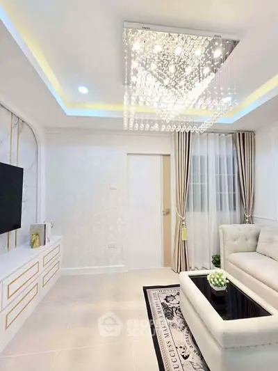 Luxurious living room with elegant chandelier and plush sofa