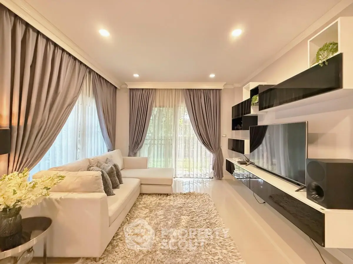 Luxurious living room with elegant decor, plush sofa, and modern entertainment center, perfect for relaxation and entertainment.
