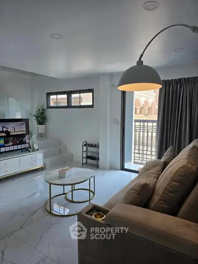 Modern living room with sleek design, large windows, and stylish furniture for a luxurious lifestyle.