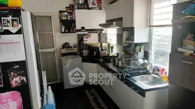 Cozy kitchen with modern appliances and ample natural light, perfect for culinary enthusiasts.
