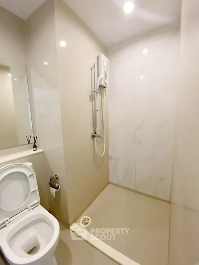 Modern bathroom with sleek shower and toilet in minimalist design