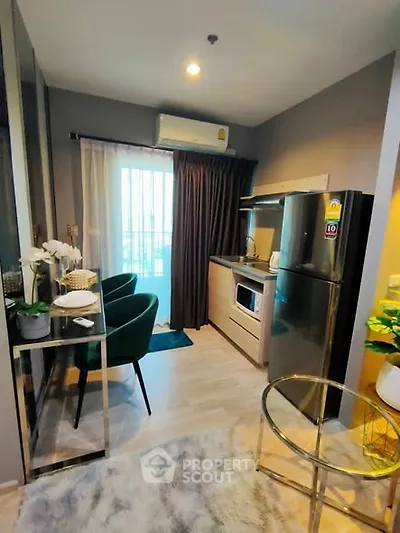 Modern compact kitchen with sleek appliances and stylish decor in a cozy apartment setting.