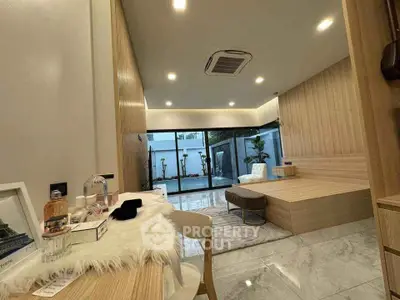 Modern living room with sleek design and large windows overlooking garden