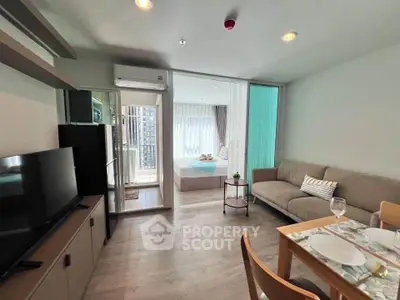 Modern open-plan living room with cozy seating and stylish decor in a contemporary apartment.