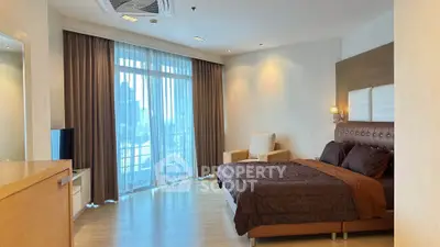 Luxurious bedroom with elegant decor and city view balcony