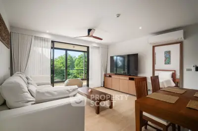Spacious living room with modern decor and large window offering lush green views.