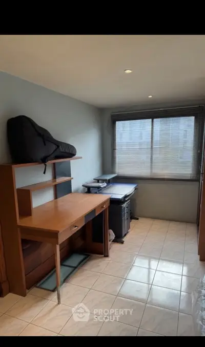 Cozy study room with desk and printer, ideal for productivity.