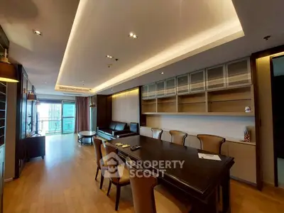 Spacious modern living room with elegant dining area and city view.