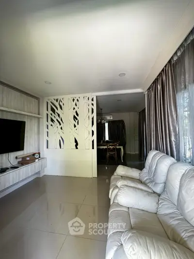 Spacious living room with modern decor and comfortable seating
