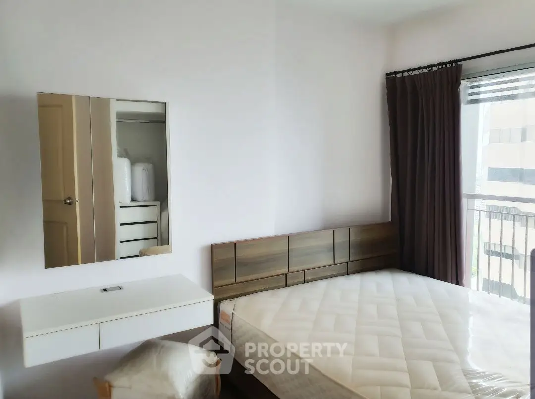 Modern bedroom with minimalist design, featuring a large window and stylish furniture.