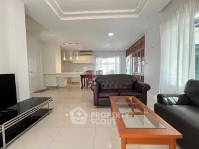 Spacious modern living room with open kitchen and elegant furnishings