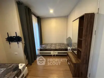 Cozy bedroom with wooden flooring and modern furniture, perfect for comfortable living.