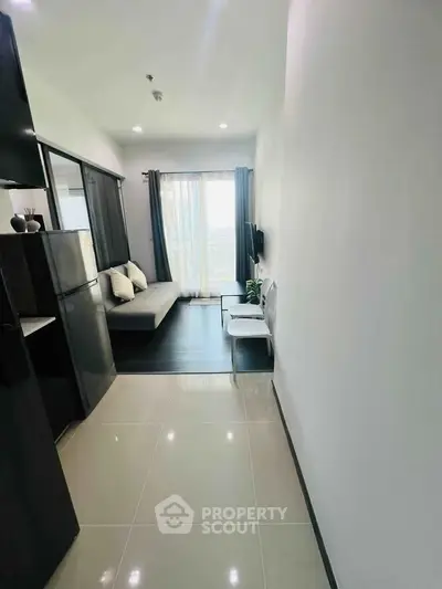 Modern living room with sleek design and natural light, featuring a cozy sofa and stylish decor.