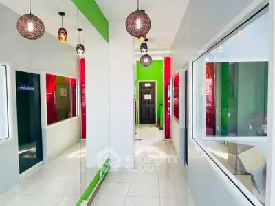 Bright hallway with modern lighting and colorful walls in a contemporary building.