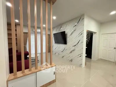 Modern living room with marble accent wall and sleek TV setup