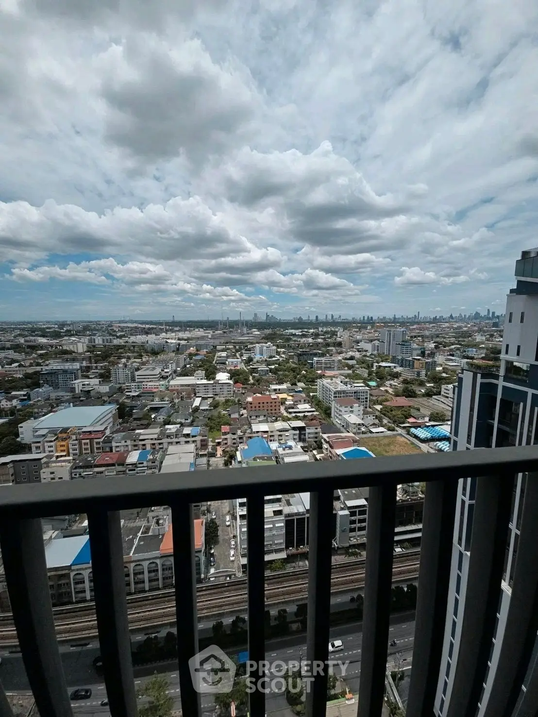 Stunning cityscape view from high-rise balcony with expansive skyline.