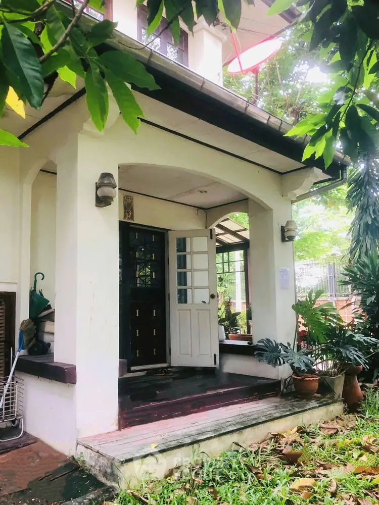Charming house entrance with lush greenery and inviting porch