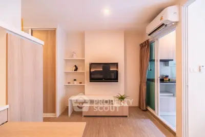 Modern living room with wall-mounted TV and air conditioning in cozy apartment