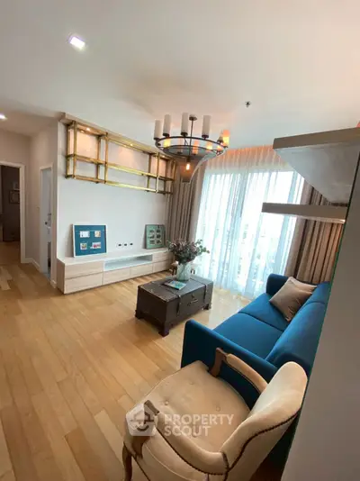 Stylish living room with modern chandelier and large windows