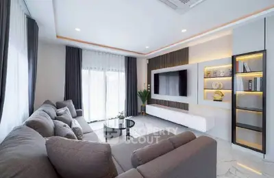 Modern living room with sleek furniture and large windows