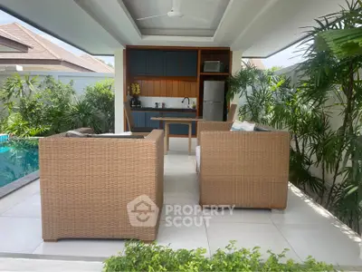 Luxurious outdoor patio with modern kitchen and pool view, perfect for relaxation and entertaining.