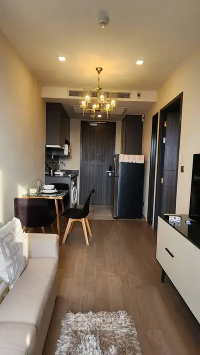 Modern apartment interior with cozy living room and compact kitchen featuring stylish furniture and appliances.