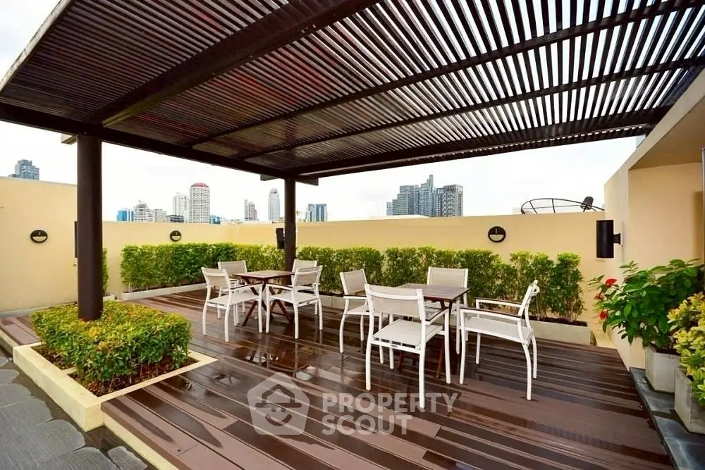 Stunning rooftop terrace with modern pergola and city skyline views.