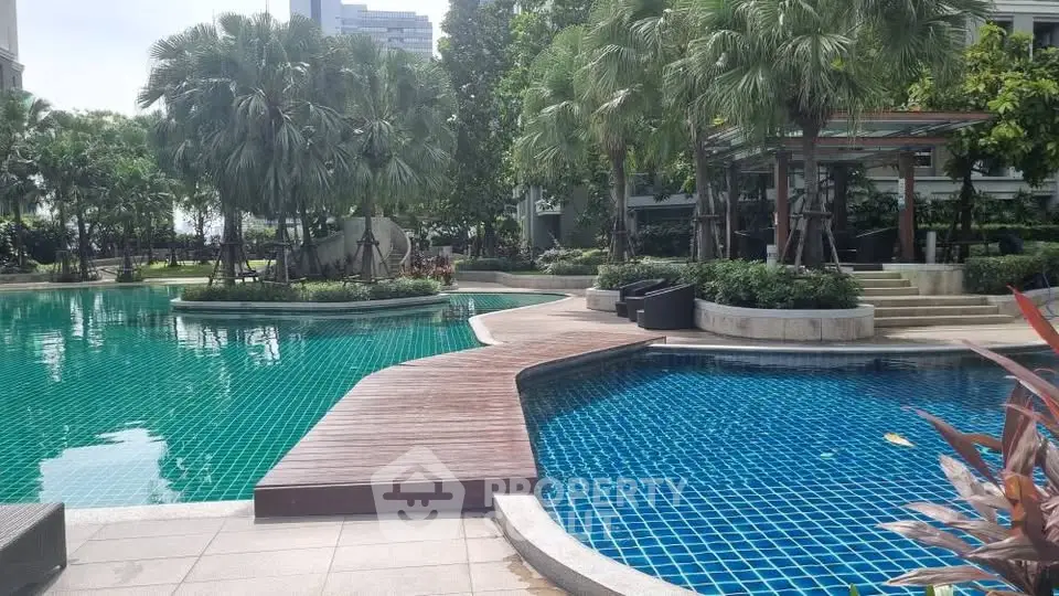 Luxurious residential pool area with lush greenery and modern design